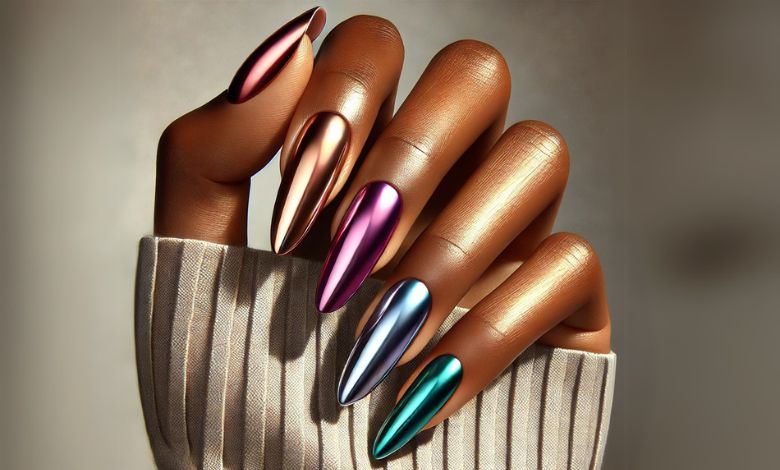 A medium-skinned hand with chrome nail polish showcasing shades of rose gold, bronze, iridescent purple, and teal. Each nail features a unique shade, set against a neutral background, emphasizing warmth and depth for a chic and versatile look.